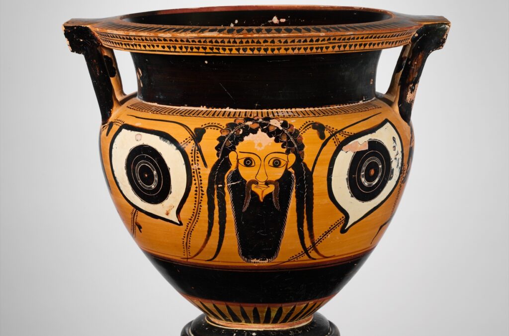 Vase grec à figures noires : un masque barbu peint entre deux grands yeux, sur la panse d'un cratère.